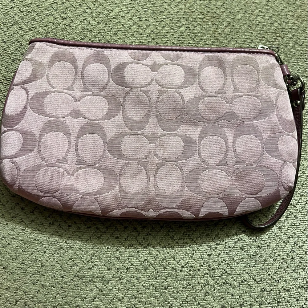 Coach wristlet.  EUC. Pinkish/mauve color.  Approximately 8.5 x 5.5